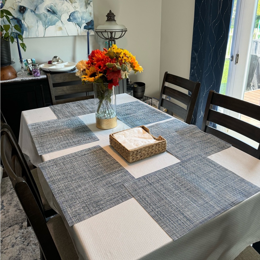 Six blue, gold and gray placemats.